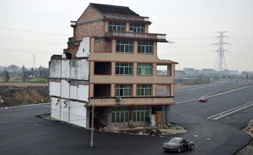 House sits in the middle of newly built road in Wenling city, Zhejiang province, China - 22 Nov 2012