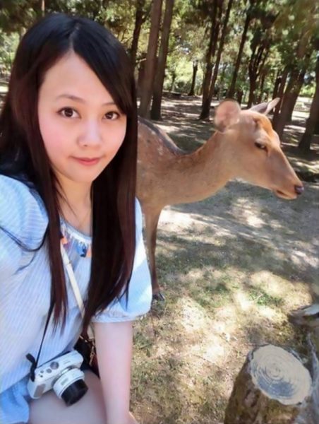 Pic shows: Huang Qiqi with the sika deer in Nara, Japan; A viral photo has captured the moment a young woman was given a hilarious death stare by a fed up deer after she pulled out her phone to take a selfie. Huang Qiqi, the woman from Taiwan, said she was eager to "do as Romans do" when she recently visited the extremely popular Nara Park, which is in Nara City of Japanís central Nara Prefecture. The park is home to adorable sika deer (Cervus nippon), which are indigenous to East Asia and famous for the trademark spots on their bodies. Huang, who shared her selfie with friends on social media, said she crouched down next to the sika doe and prepared her mobile phone to take the picture. But afterwards she could not help laughing at the "uncooperative" animal, which seemed not at all impressed by her selfie attempt and produced the stern stare into her camera lens. The sika, also known as the spotted deer or the Japanese deer, is now something of an internet celebrity after Huangís photo went viral with more than 10,000 likes. Thankfully, the animalís reluctance to take part in the customary selfie will not stop tourists from flooding to Nara City, which has temples and iconic artwork from the 8th century, when it was Japanís capital. Subspecies of the sika deer can also be found in Taiwan, where it is a national animal.